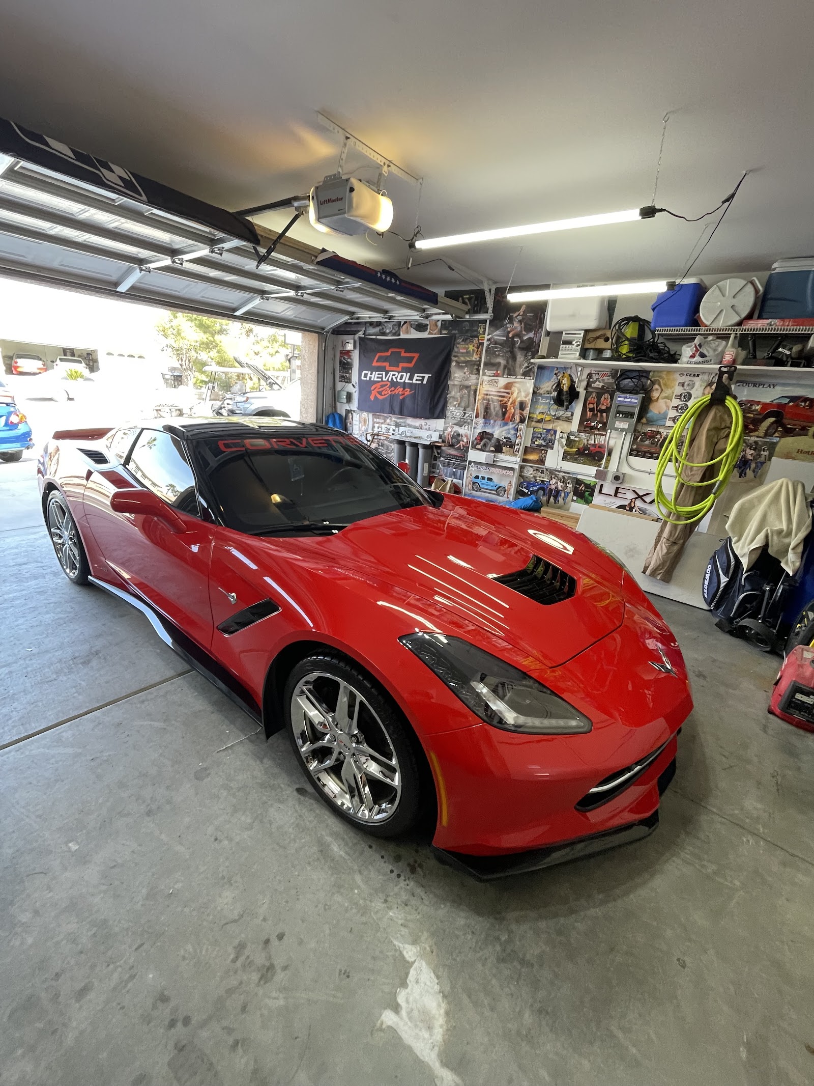 Glossy red Chevrolet Corvette detailed in a home garage