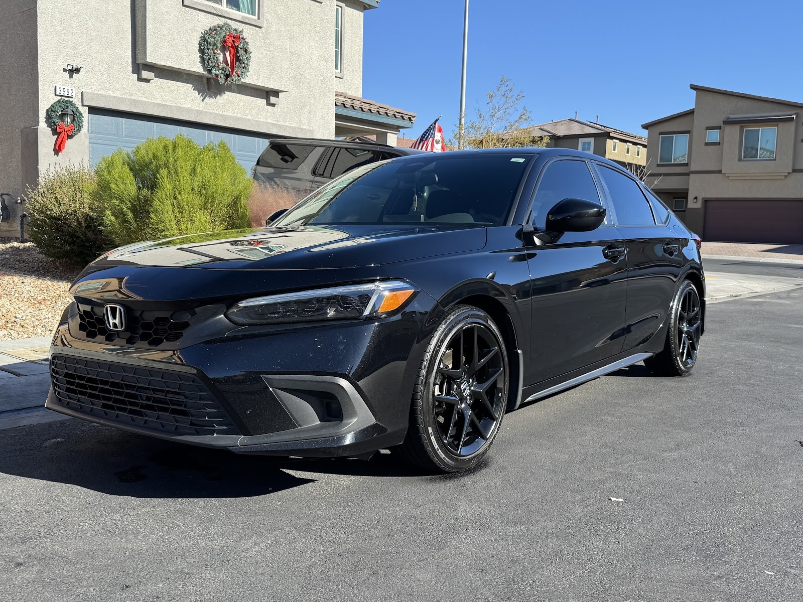 Black Honda Civic hatchback detailed with glossy finish and black wheels